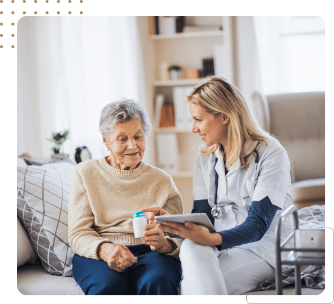 Nurse assisting elderly woman with medication.